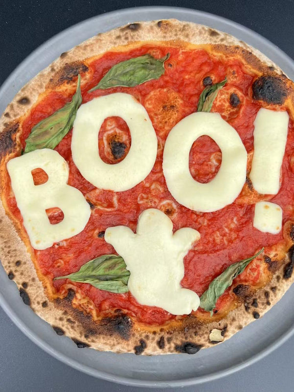 BOO Halloween margherita pizza with fior di latte cheese letters spelling BOO!
