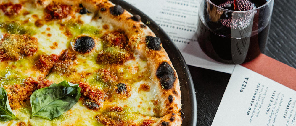 Neo Margherita pizza with san marzano dop “polpa” and basil breadcrumb with Italian red wine