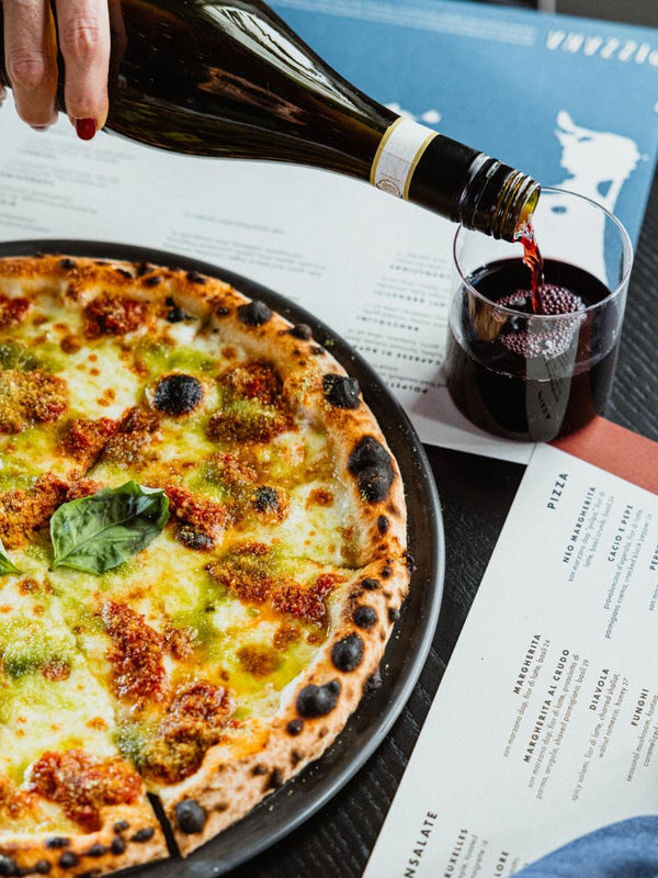 Neo Margherita pizza with san marzano dop “polpa” and basil breadcrumb with Italian red wine