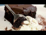 A video of a spoon scooping a bite of dark chocolate cake and vanilla ice cream