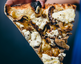 Slice of Vegan Funghi pizza with seasonal mushroom and vegan cauliflower besciamella