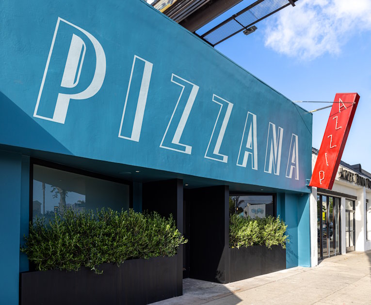 Facade of Pizzana Sherman Oaks with bright blue paint and a red sign that says “PIZZA"
