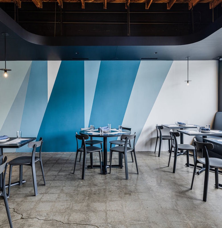 Interior of Pizzana Silver Lake with striking blue wall patterns and a spacious dining room