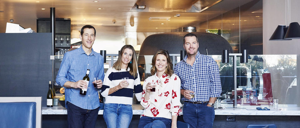 Founders Charles Nelson, Caroline O’Donnell, Candace Nelson and Chris O’Donnell holding wine at Pizzana Brentwood