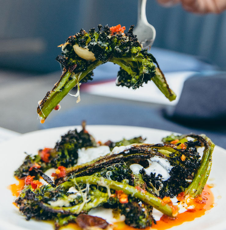 Wood fired broccolini with whipped ricotta and calabrian chile oil
