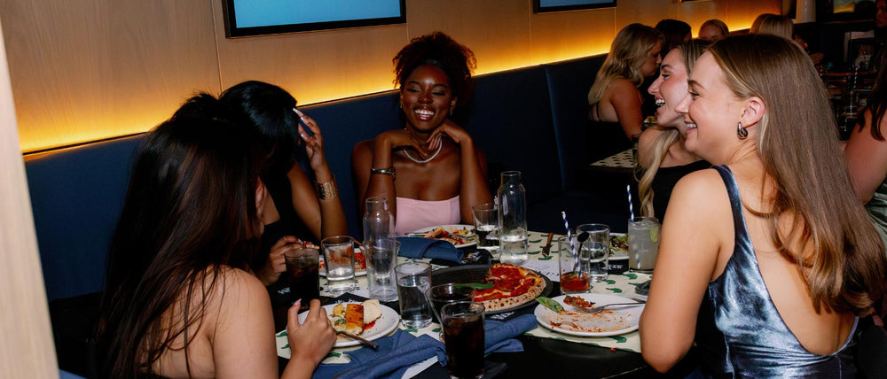 Women enjoying pizza at Pizzana