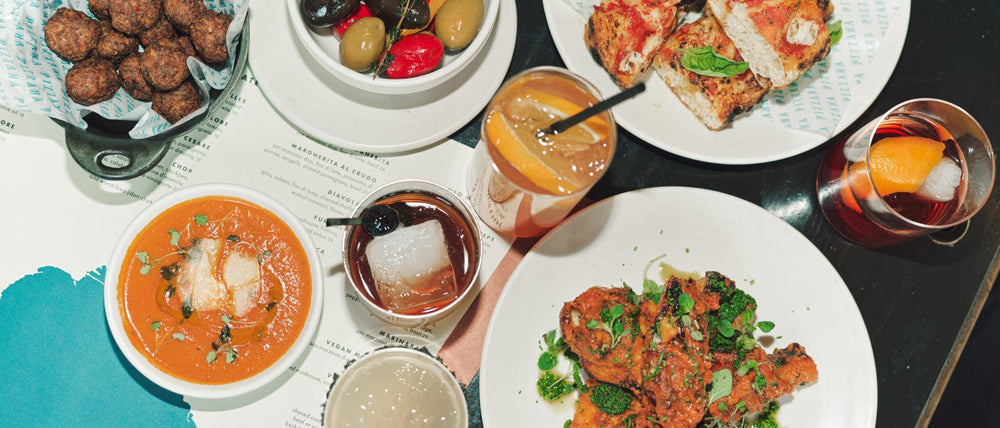 A happy hour spread of small Italian bites and cocktails