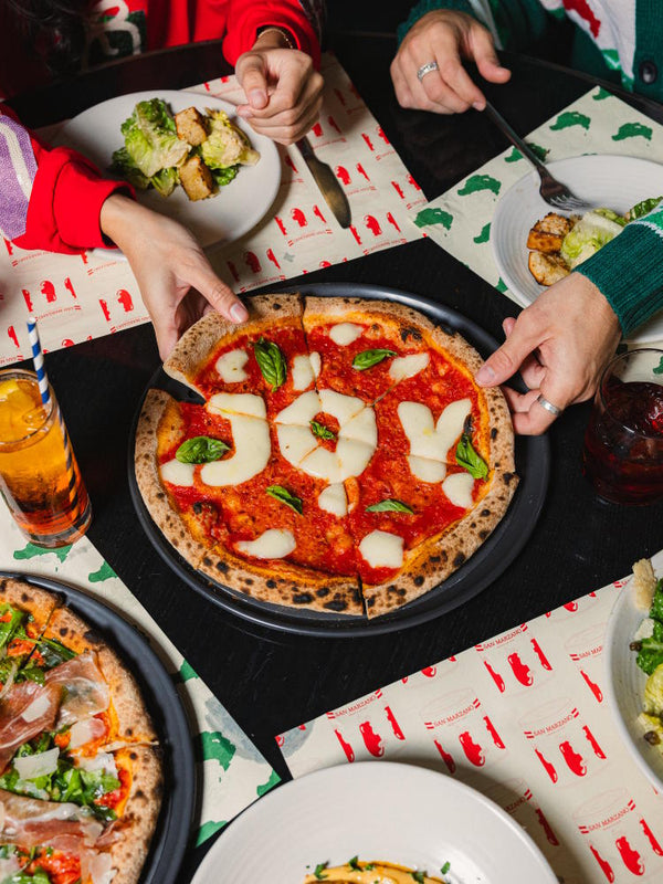 Merry Margherita pizza with JOY written in fior di latte cheese letters