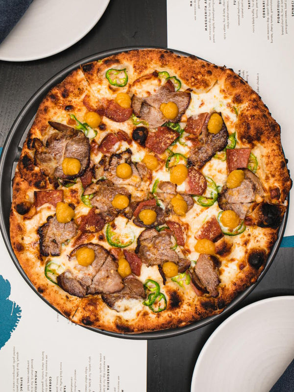 Sacrilegio pizza with roasted pork, spam, smoked fior di latte, jalapeno, pineapple jam