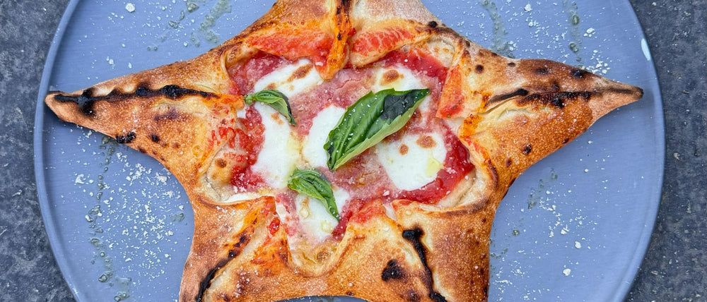 Stella pizza shaped in a star for the holidays with fior di latte, san marzano top and basil