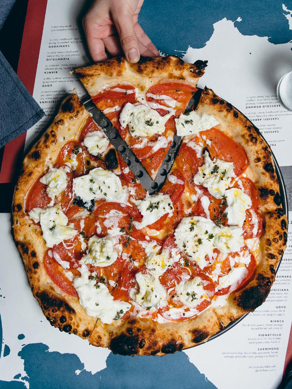 Sud a Sud pizza featuring California San Marzano tomatoes, mozzarella di bufala dop, garlic and thyme