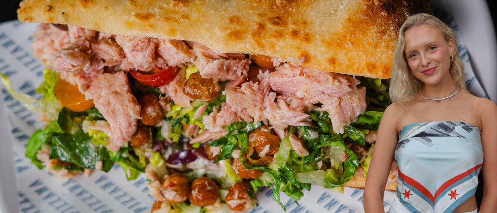 A tuna sandwich on focaccia with an image of influencer Brett Chody of Brett’s Bites