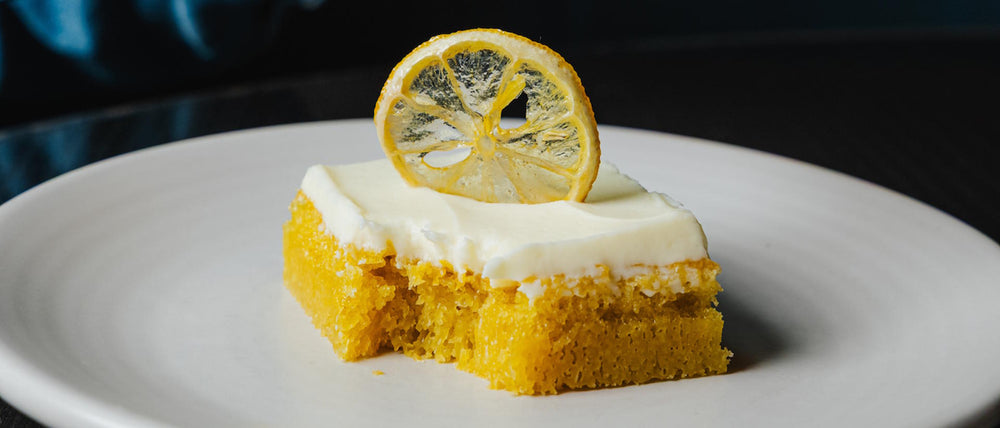 Torta al Limone Italian lemon cake featuring white chocolate frosting and a candied lemon garnish