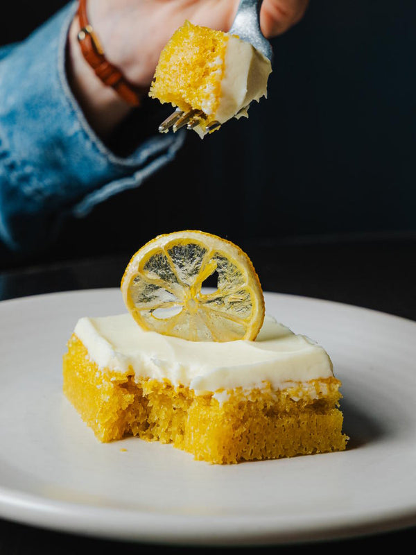 Torta al Limone Italian lemon cake featuring white chocolate frosting and a candied lemon garnish