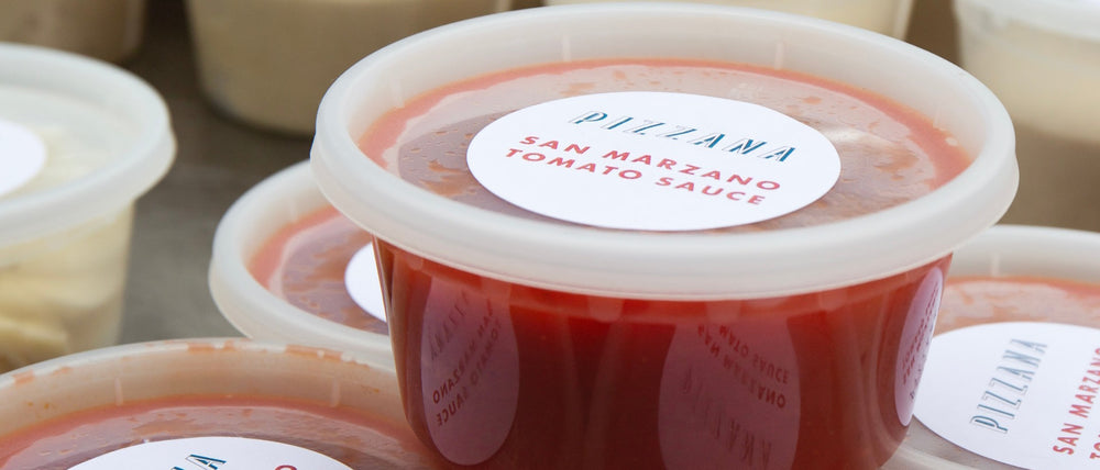 Fresh, bright red San Marzano tomato sauce in a to go container