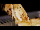 Video of a hand taking a slice of hot Cacio e Pepe pizza revealing a cheese pull