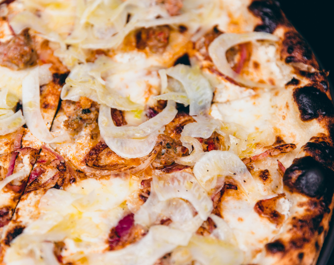Closeup of Bianca pizza with sausage, fior di latte, fennel and onion