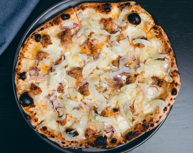 Bianca pizza with sausage, fior di latte, fennel and onion
