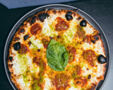 Neo Margherita pizza with basil breadcrumb and san marzano polpa